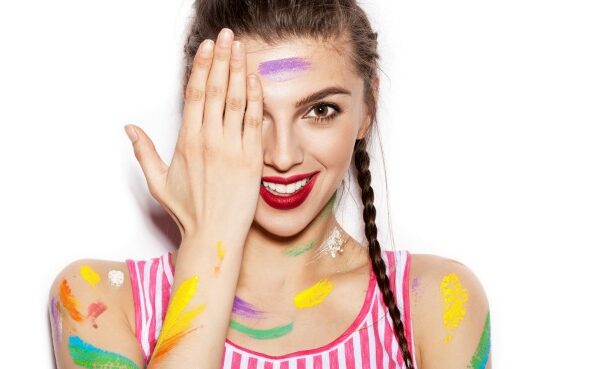 Girl covered in streaks of colored paint