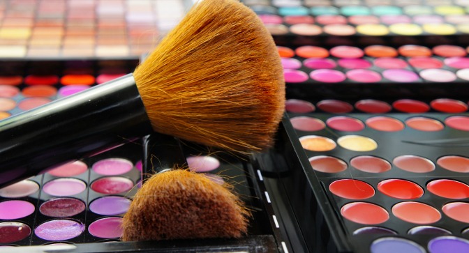 Makeup brushes on bright palettes