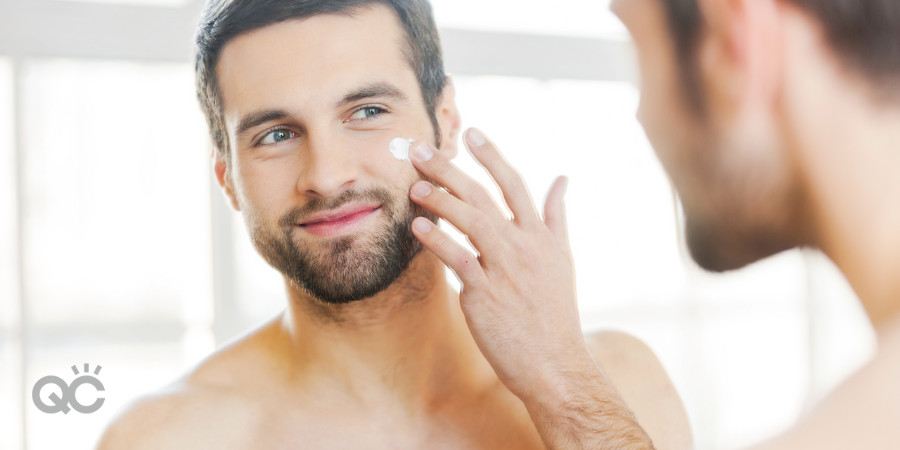 man using moisturizer after cleansing his face