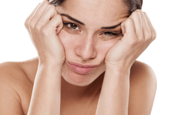 sad and disappointed young woman on a white background