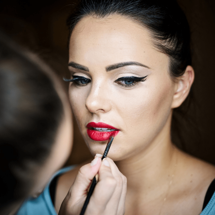 professional makeup artist applies makeup on model for online makeup class