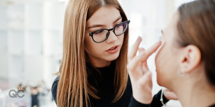 model having makeup applied on her by makeup business owner and artist