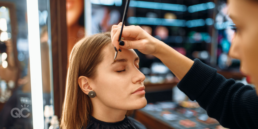 makeup artist applying makeup on a client