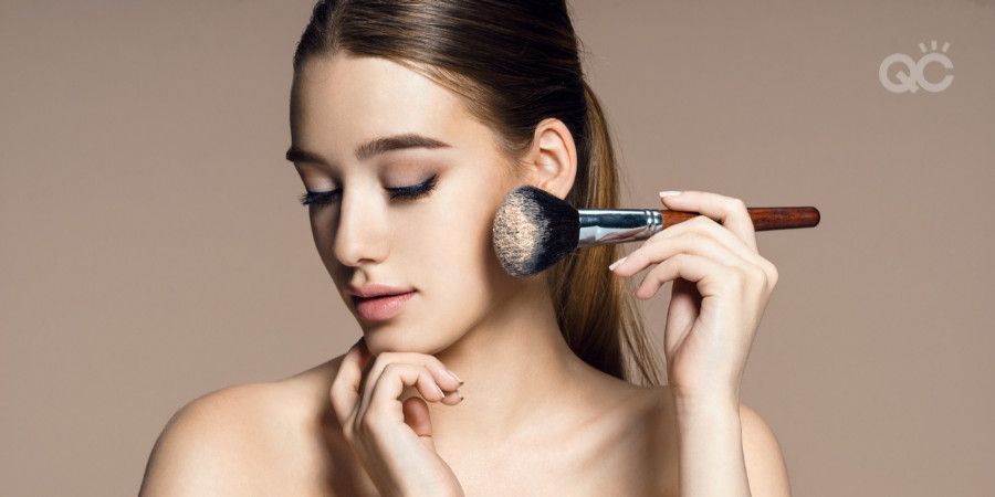 makeup items you don't need - girl putting on powder with brush