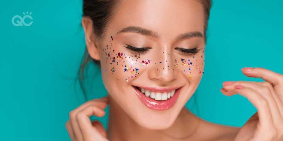 smiling girl with glitter on her cheeks