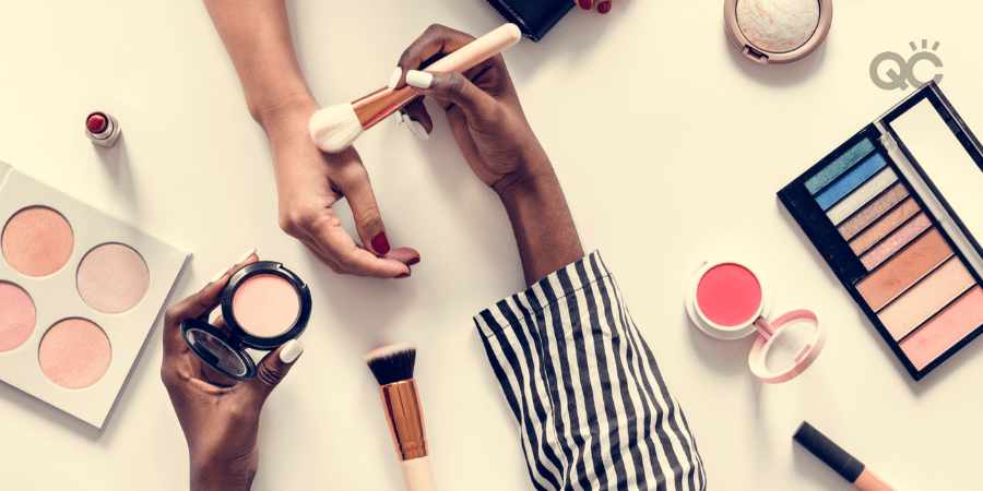 hands and makeup on table - mua testing powder shade on model's hand