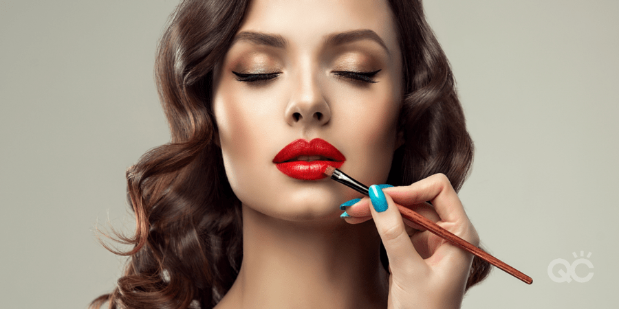 upclose shot of models face, and mua's hand applying product to her lips