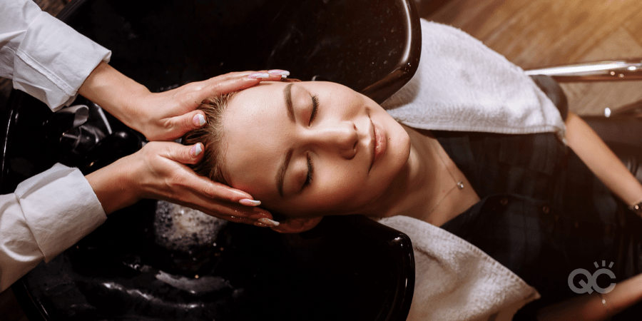 hair stylist washing client's hair