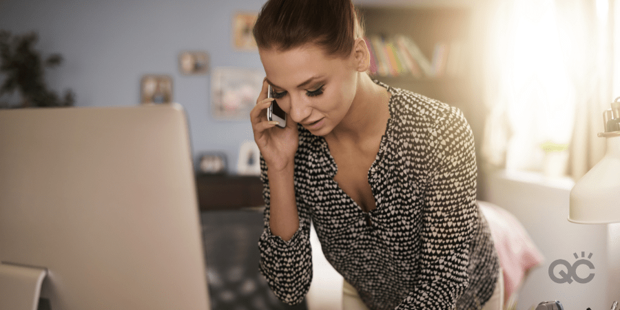 busy woman on phone and typing on computer