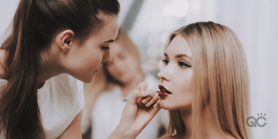 brunette mua doing blonde model's makeup