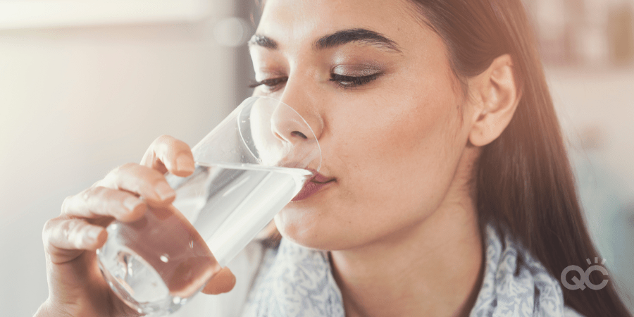 Young woman drinking pure glass of water