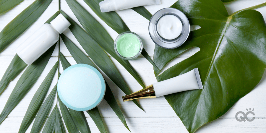 Natural cosmetics and leaves on table