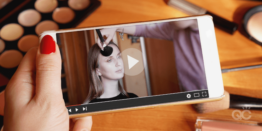 Mobile video of professional makeup artist applying makeup on model