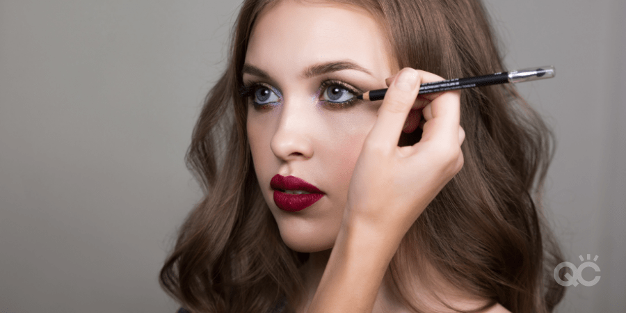 Makeup artist applying eyeliner to model - makeup artist practice article