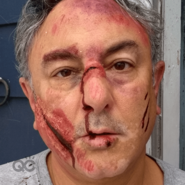 makeup artist certification graduate, Mark Lenzi, wearing bruise and wounds SFX makeup