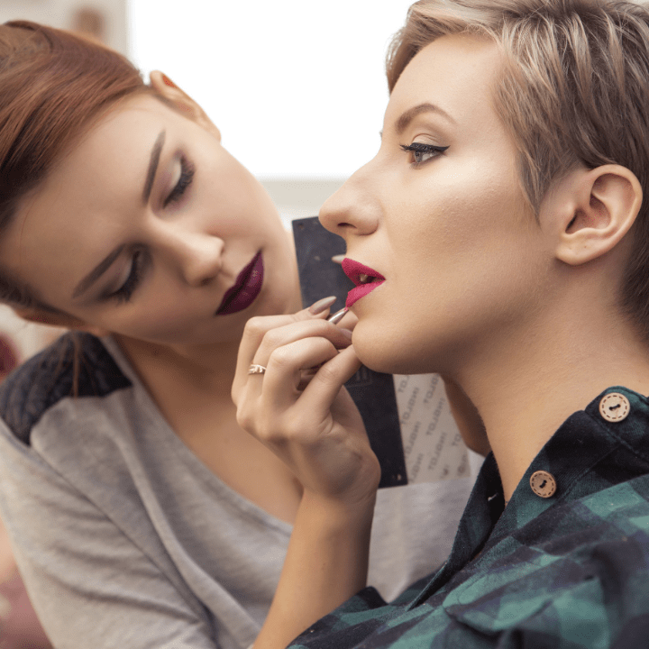 makeup artist doing makeup on female client