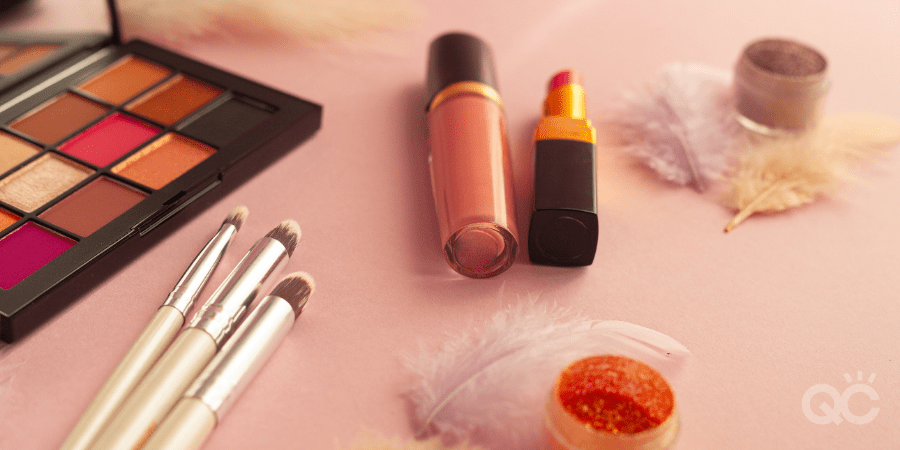 makeup products on pink surface