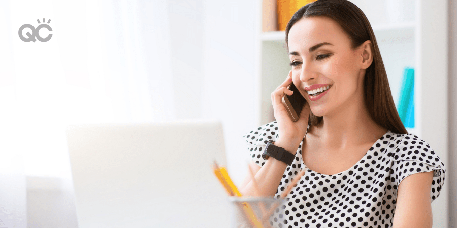 makeup artist looking at laptop and on phone call