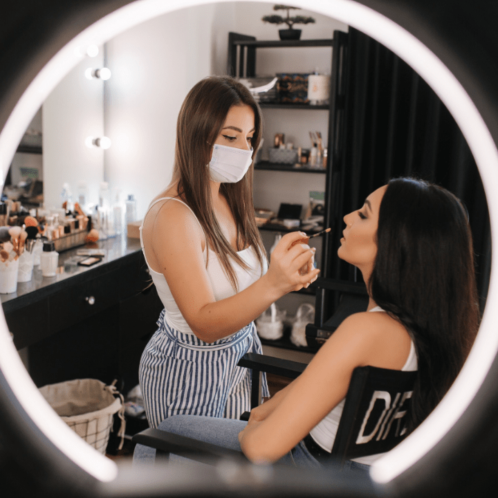 makeup jobs MUA working with client while wearing mask