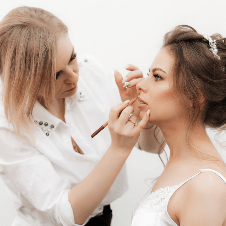 how to become a makeup artist, MUA doing makeup on bridal client