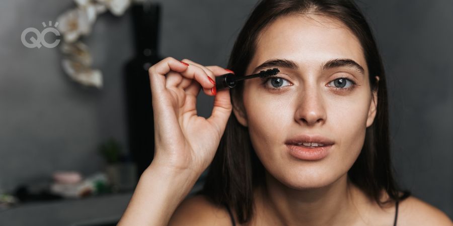 Woman applying makeup at home