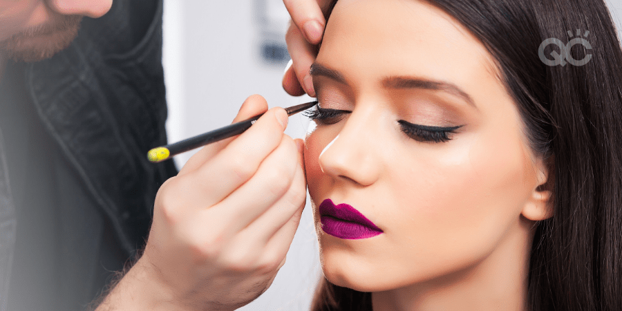 male makeup artist applying makeup on female client