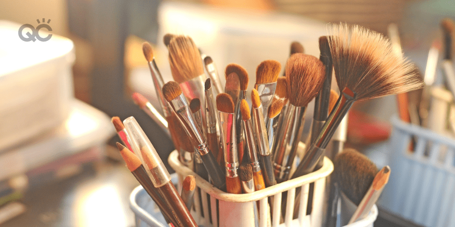 makeup brushes in container on table