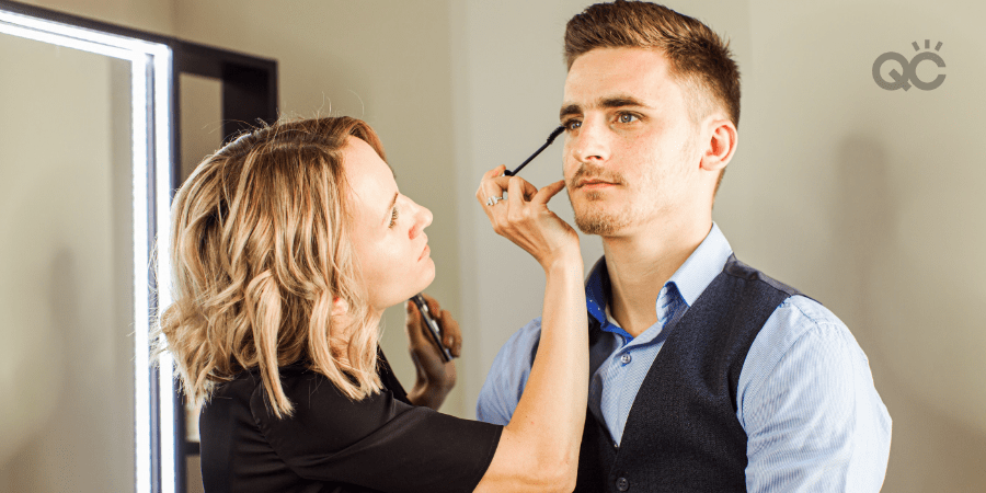 makeup artist working on male client