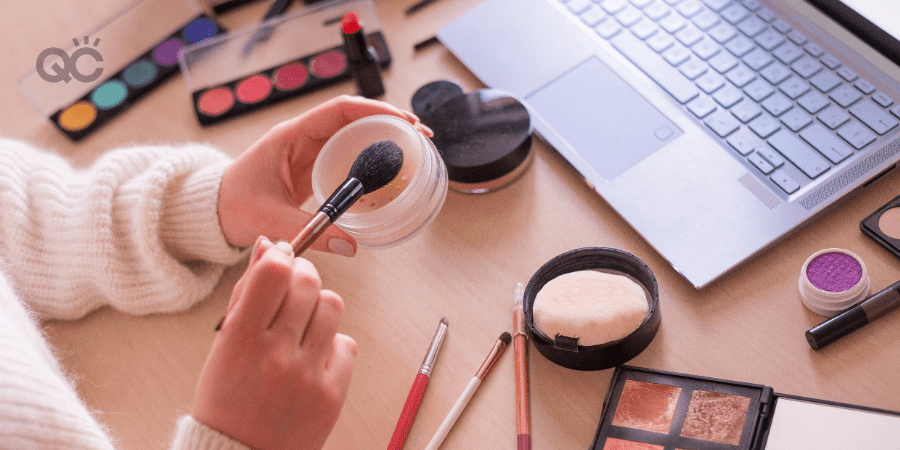 woman learning how to do makeup from laptop video