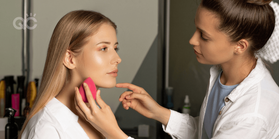 makeup artist applying makeup to model with beauty blender