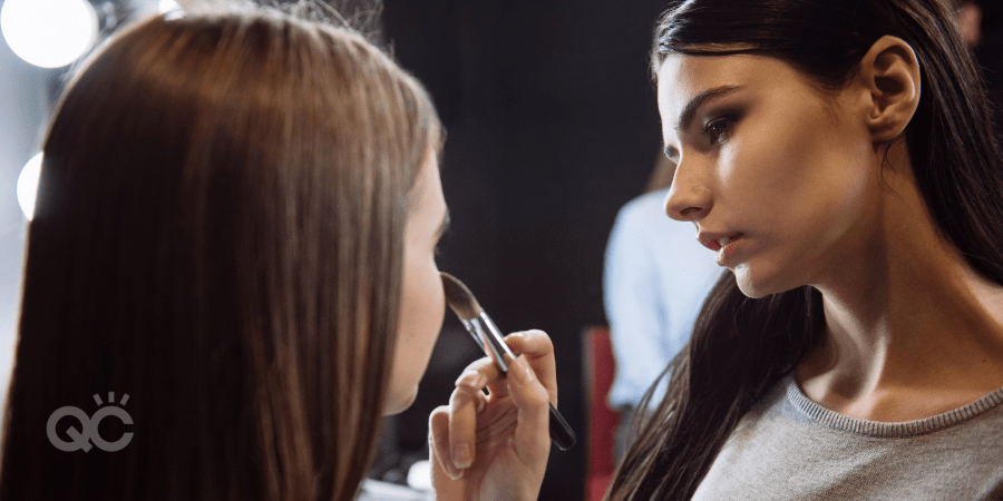 makeup artist doing editorial makeup on model