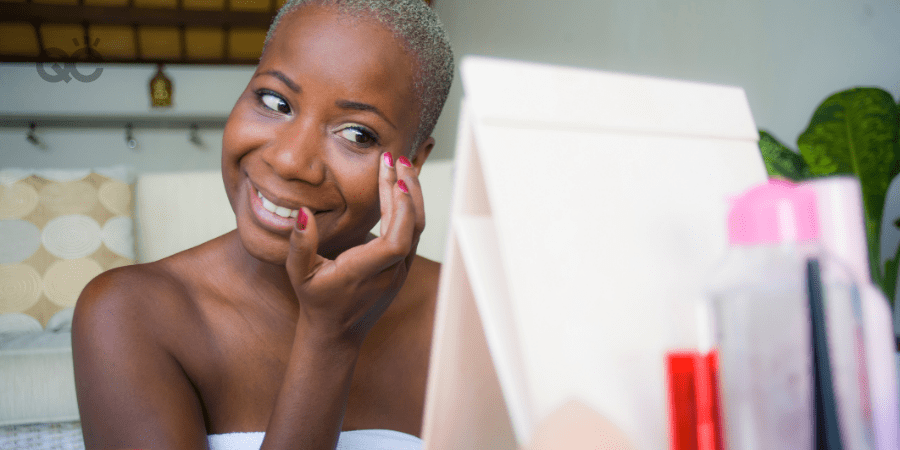 happy woman applying makeup on face