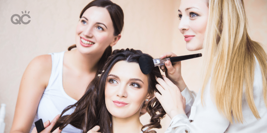 makeup artist working on client with hair stylist