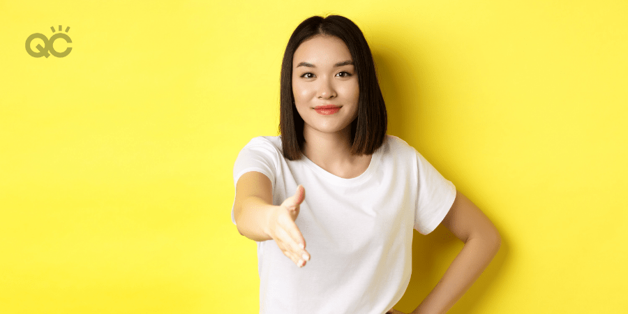 woman holding out her hand, introducing herself