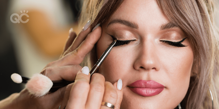 model having makeup applied on her closed eyes