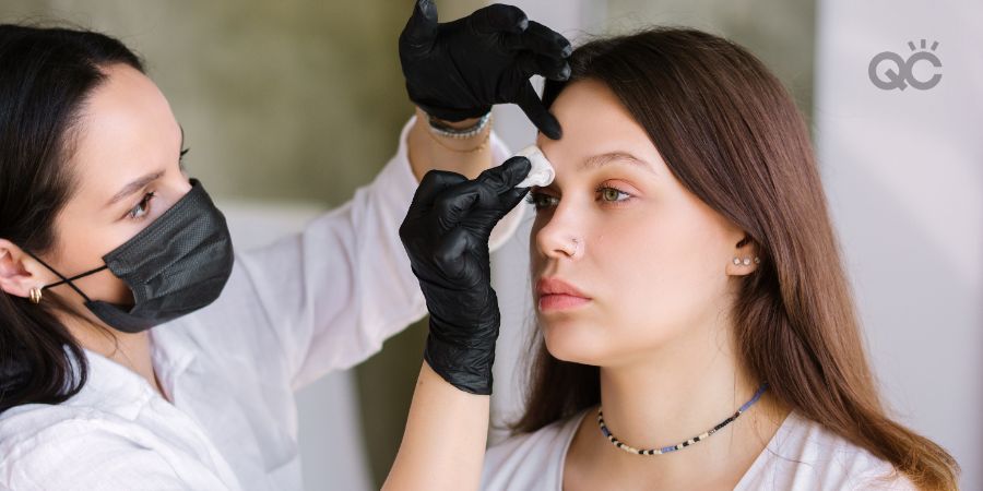 Makeup artist removing makeup from client's face