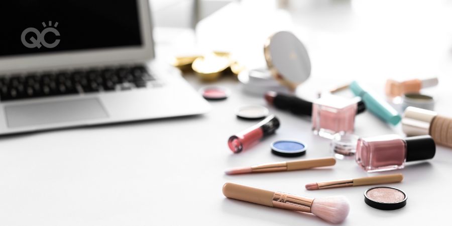 Makeup products for woman and laptop on table