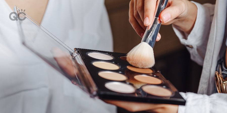 Makeup artist working from contour palette