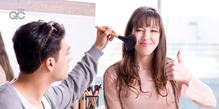 Man doing makeup on female client in beauty salon