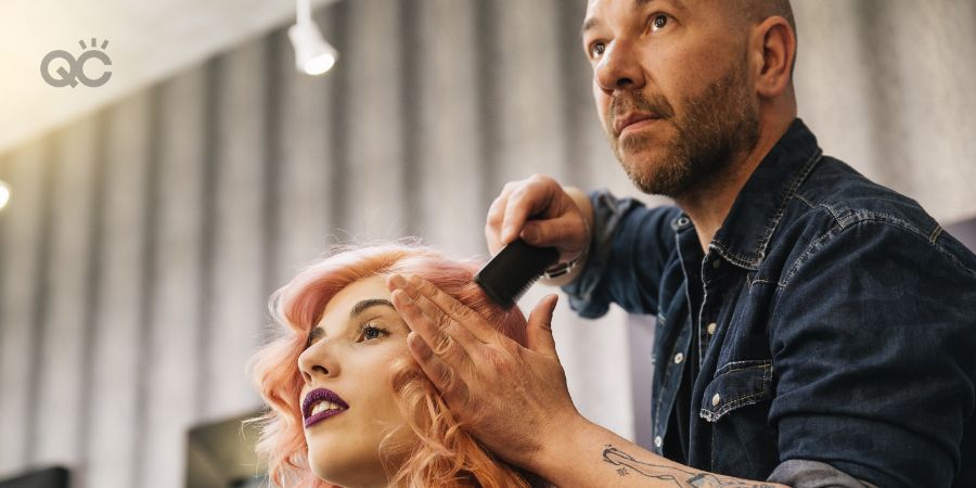 Beautiful woman getting haircut by hairdresser in the beauty salon.