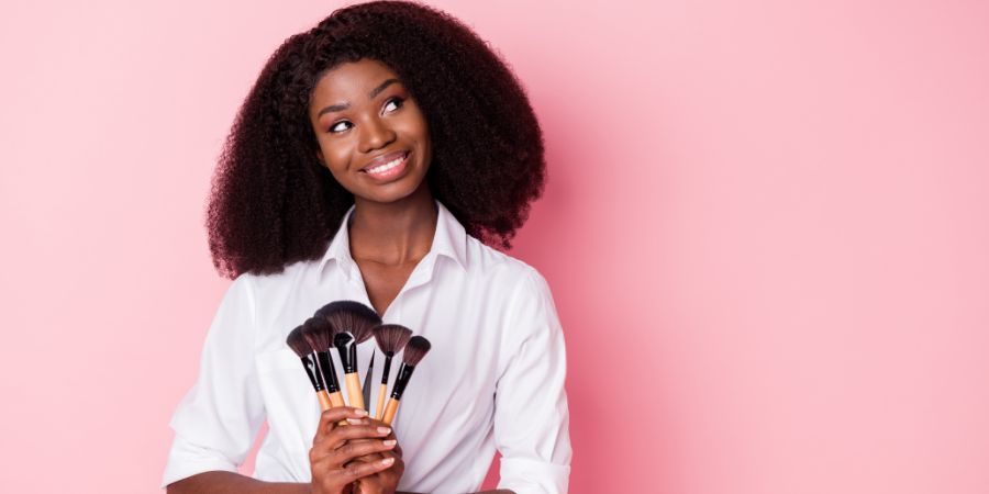 Photo of nice optimistic brunette hairdo lady apply make up look empty space wear white shirt isolated on pink color background. Market makeup business article.