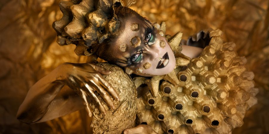 Golden eggs. Luxurious model. Gold bodypainting. Glamorous beautiful model in gold paint. Brilliant fantasy makeup. Golden creative makeup. Fantasy image. Special effects article.