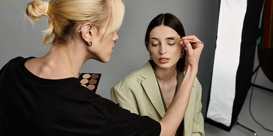 Student attending the best makeup school in Canada practices on a model