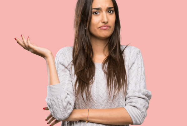 frustrated woman shrugging one arm, unsure what she's supposed to do