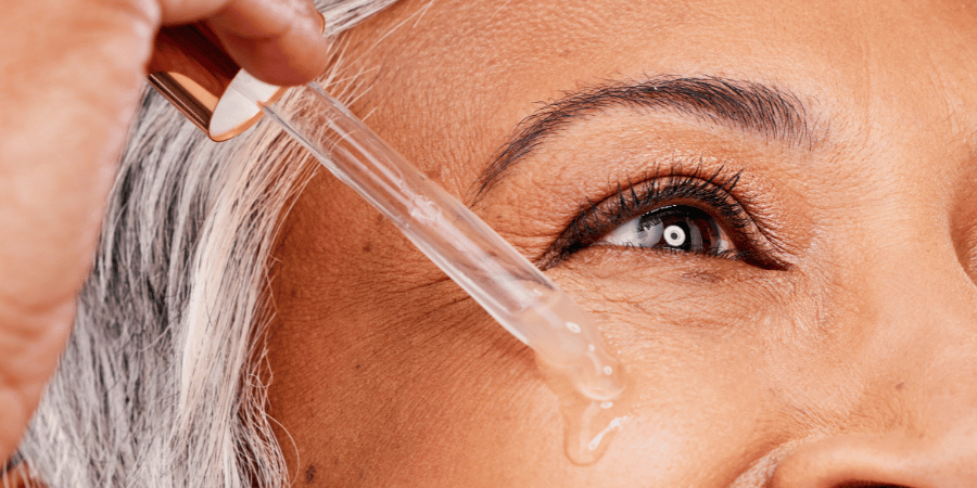 Mature makeup client prepares the skin for makeup application using hydrating product for mature skin