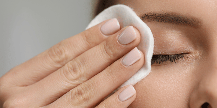 Woman removes eye makeup using gentle makeup remover